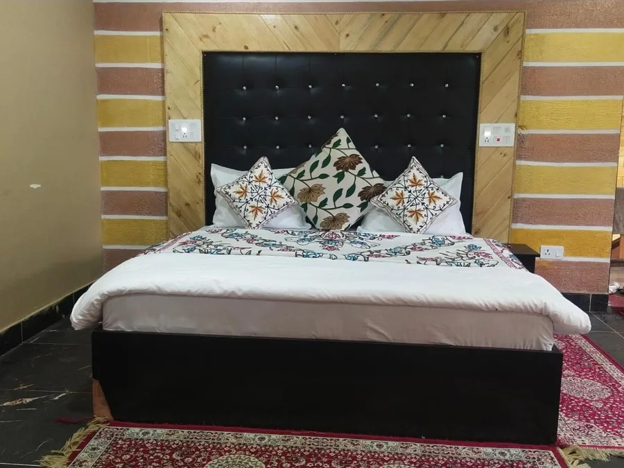 Guest room at Hotel Seven Pahalgam with a tufted headboard
